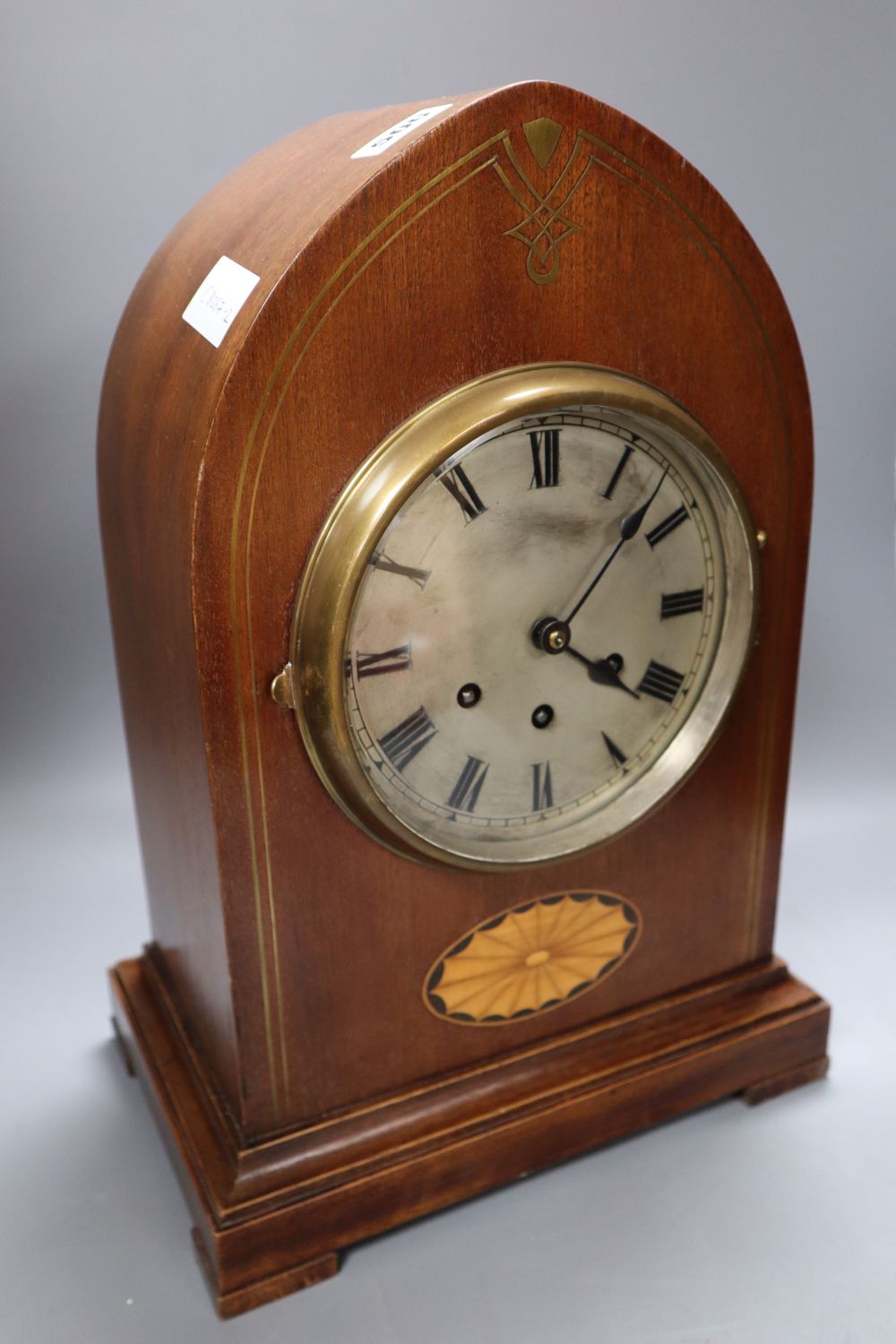 A Victorian mahogany and cut brass chiming lancet mantel clock, 6 inch silvered dial and French musical movement striking on five pipes
